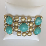 Bursting Goldtone Beads and Turquoise Resin Accents Adorn this White Leather Bracelet with Magnetic Clasp