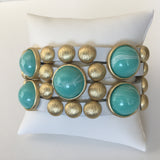 Bursting Goldtone Beads and Turquoise Resin Accents Adorn this White Leather Bracelet with Magnetic Clasp
