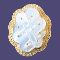 24K gold with silver and mother of pearl and diamonds
