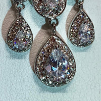 Rhodium Plated Chandelier Earrings with Dangling Oval and Pear Shaped CZs